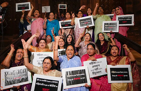 BJP MPs raise slogans during a protest, after the Constitution Amendment Bill to implement reservation for women in legislatures and increase the number of seats of the Lok Sabha was defeated, during the Special session of Parliament, in New Delhi, Friday, April 17, 2026.