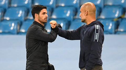 Arsenal's head coach Mikel Arteta (L) amd Manchester City's manager Pep Guardiola