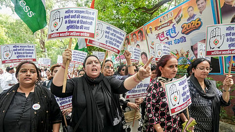 Congress workers hold placards during a protest march towards the BJP headquarters against the Constitution (131st Amendment) Bill on womens reservation, in New Delhi, Sunday, April 19, 2026.