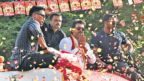 TVK leader Vijay canvassing for votes during his roadshow at Wireless Road in KK Nagar, Tiruchy, on Sunday.