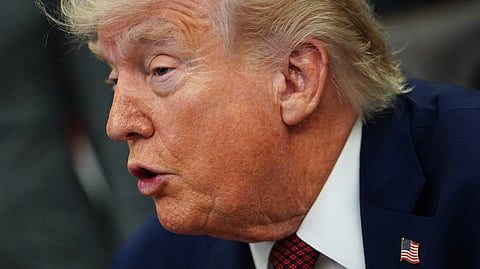 President Donald Trump listens to speeches before signing an executive order in the Oval Office of the White House, Saturday, April 18, 2026, in Washington.