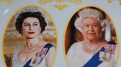 A plate with photos of the late Queen Elizabeth II is on display for sale at a souvenirs shop in London on April 17, 2026.