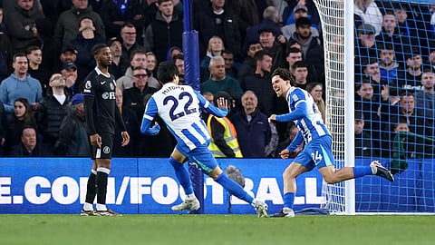 Brighton and Hove Albion's Ferdi Kadioglu, right, celebrates scoring their side's first goal during the EPL soccer match between Brighton & Hove Albion and Chelsea on Tuesday, April 21, 2026.