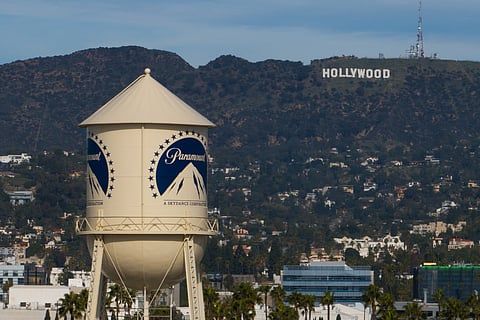 The Paramount Pictures water tower is seen in Los Angeles, Dec. 18, 2025, with the Hollywood sign in the distance.