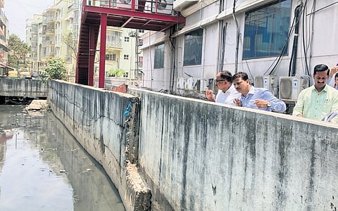 Bengaluru South City Corporation Commissioner K N Ramesh inspects a stormwater drain where desilting has to be carried out