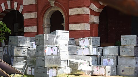 Police and CRPF personnel stand guard outside the sealed strong rooms at Anna University in Chennai, where the EVM control units of the South Chennai Assembly constituencies are securely stored following the elections.