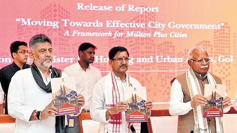 Deputy Chief Minister DK Shivakumar and Union Minister Manohar Lal Khattar (right) release a report ‘Moving Towards Efficient City Government: A Framework for Million Plus Cities’ during the 56th Foundation Day and Symposium organised by the Ministry of Housing and Urban Affairs in New Delhi on Saturday.