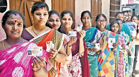Hundreds of voters wait in que to cast their vote at a polling booth at Sacred Heart Mtr. School, Korukkupet, in Chennai on Thursday.