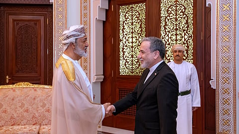 In this photo released by the Iranian Foreign Ministry, Iranian Foreign Minister Abbas Araghchi, right, shakes hands with Oman's Sultan Haitham bin Tariq during their meeting, in Muscat, Oman, Sunday, April 26, 2026.