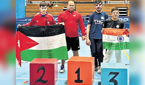 Tushar proudly holds up the Tricolour at a sporting event in which he participated.