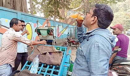 A man drinks Goli Soda from a roadside cart in Cuttack.