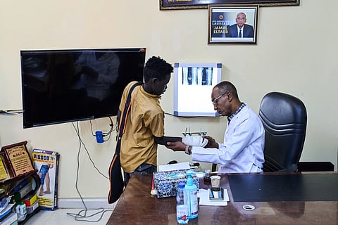 Dr. Jamal Eltaeb checks a patient at Al Nao Hospital in Omdurman, on the outskirts of Khartoum, Saturday, April 18, 2026.