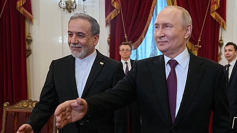 Russian President Vladimir Putin, right, and Iranian Foreign Minister Abbas Araghchi walk to attend the talks at the Boris Yeltsin Presidential Library, in St. Petersburg, Russia, Monday, April 27, 2026.