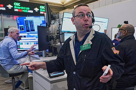 Options trader Matthew Hefter, center, works on the floor of the New York Stock Exchange, Thursday, April 23, 2026.