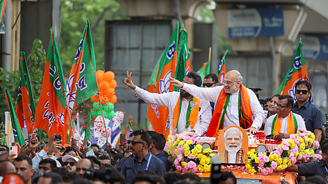Union Home Minister Amit Shah during a roadshow at Behala Paschim for the West Bengal Assembly elections, in Kolkata.