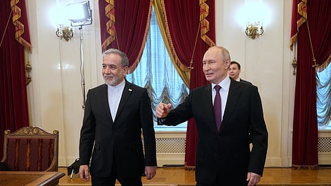 Russian President Vladimir Putin, right, and Iranian Foreign Minister Abbas Araghchi walk to attend the talks at the Boris Yeltsin Presidential Library, in St. Petersburg, Russia, Monday, April 27, 2026.