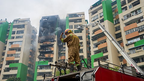 A firefighter douses a fire that broke out in Green Avenue Society, Indirapuram, Ghaziabad, Wednesday, April 29, 2026.