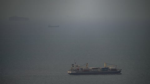 A cargo ship sails in the Persian Gulf toward the Strait of Hormuz, Wednesday, April 22, 2026.