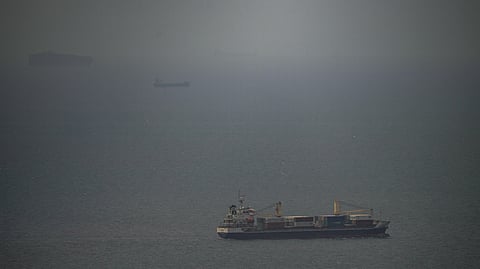 A cargo ship sails in the Persian Gulf toward the Strait of Hormuz, Wednesday, April 22, 2026.