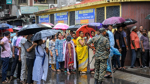 Howrah: People wait in queues amid rain before casting their votes in the second and final phase of the West Bengal Assembly elections, at a polling station in Howrah, Wednesday, April 29, 2026.