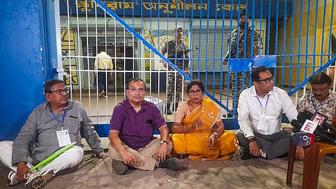 TMC candidates Kunal Ghosh, second left, and Shashi Panja, centre, and others stage a sit-in protest outside a strong room at Khudiram Anushilan Kendra, ahead of the counting of votes for the West Bengal Assembly elections, in Kolkata, Thursday, April 30, 2026.