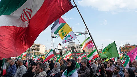 A man waves a representation of the Iranian flag during a state-organised rally in Tehran, Iran, Wednesday, April 29, 2026.