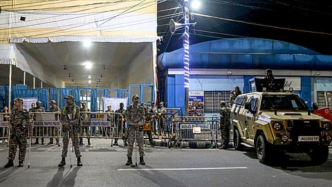 Security personnel stand guard outside a strong room, ahead of the counting of votes for the West Bengal Assembly elections, at the Khudiram Anushilan Kendra, in Kolkata, Friday, May 1, 2026.