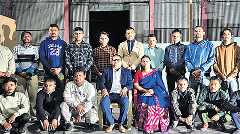 With his wife and workers.