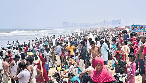 To get respite from the hot summer, families throng Marina Beach and enjoy the cool sea breeze on Sunday.