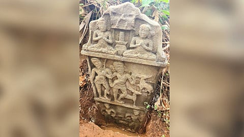 The rectangular stone slab, measuring approximately 45 inches in height and 22.5 inches in width, features intricate carvings arranged in three panels.