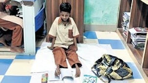 Laxmi Khemudu, a Class X student writing her exam with her feet.