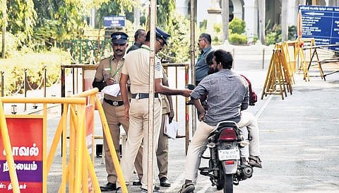 Police personnel checking credentials of a visitor at Loyola College.