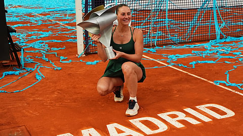 Marta Kostyuk of Ukraine celebrates with the trophy after winning the final match at the Madrid Open tennis tournament in Madrid, Spain, Saturday, May 2, 2026.
