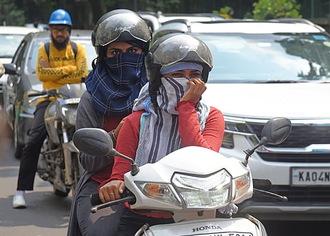 Despite three days of rain, Bangaloreans shield themselves with scarfs and sleeves to beat the heat as mercury level rises in Bengaluru on Sunday.