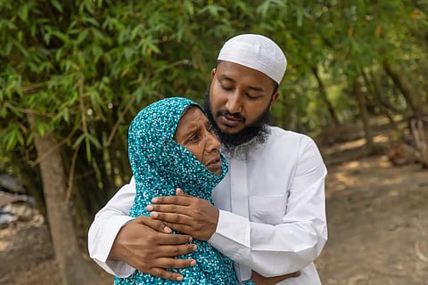 Maruf Hasan, brother of Mohammad Abdullah Al Mamun comforts his mother, Shahida Khatun, as she weeps at their home in Rasulpur village in Mymensingh district, Bangladesh, Friday, April 17, 2026.