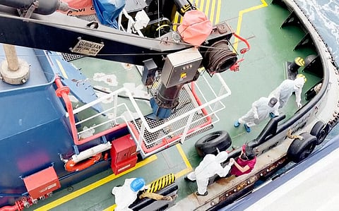 Health workers get off the Dutch-flagged MV Hondius, a cruise ship carrying nearly 150 people as it remains off Cape Verde on Monday, May 4, 2026 after three passengers died and several others fell seriously ill in a suspected hantavirus outbreak.
