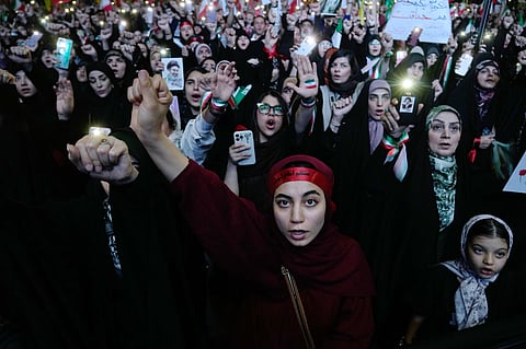 Pro-government demonstrators chant slogans during their gathering at Enqelab-e-Eslami, or Islamic Revolution, square in Tehran, Iran, Monday, May 4, 2026.