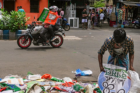A ragpicker collects usable items from debris near the TMC party office, after it was vandalised in the Tollygunge area, a day after the declaration of West Bengal Assembly election results, in Kolkata, Tuesday, May 5, 2026