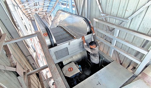 Railway staff examining the escalator at Thiruvananthapuram Central Railway Station on Wednesday.
