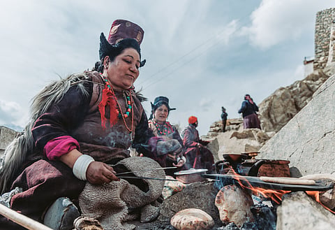 Native Ladakhi women cooking bread
