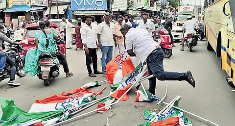 Ripped Congress party flags strewn across the road amid the commotion in Mayiladuthurai.