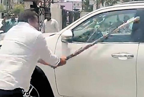BRS MLA Padi Kaushik Reddy’s car being damaged allegedly by a BJP worker at the camp office of legislator Gangula Kamalakar in Karimnagar on Thursday