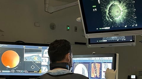 Libyan Dr. Faysal Alghoula shows him performing robotic bronchoscopy to diagnose lung cancer at his clinic in Evansville, Ind., in 2024.