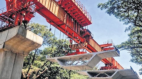 Work on installing the remaining 15 of 762 spans between structural supports of the Ejipura flyover goes on in full swing on Friday.