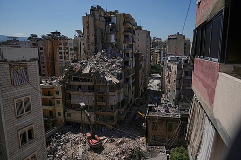 Rescue workers search through the rubble of a building destroyed in an Israeli airstrike the previous day in Dahiyeh, Beirut's southern suburbs, Lebanon, Thursday, May 7, 2026.