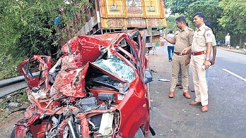 The mangled remains of the car on the Tumakuru–Maddur State Highway