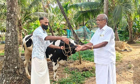 K Mahesh giving his cow to Kunnath Mustafa after losing a friendly election bet.