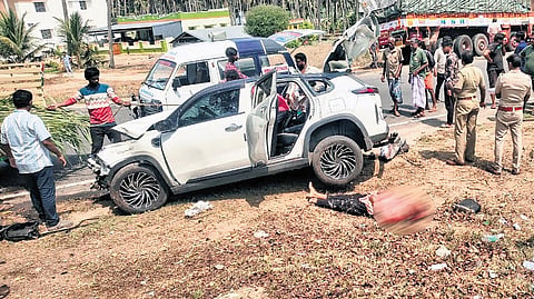 The mangled remains of the car hit by a lorry on the Pollachi-Palladam main road near Negamam in Coimbatore on Monday afternoon
