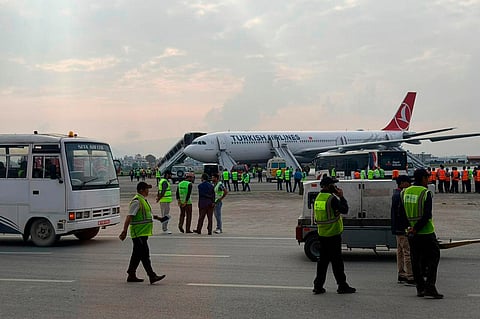 A Turkish Airlines aircraft is seen after passengers were safely evacuated and Nepal's main airport shut down, following a fire on the jet while landing in Kathmandu, Monday, May 11, 2026.