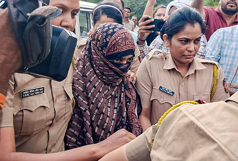 Police personnel escort Nida Khan, the prime accused in the TCS Nashik case involving alleged sexual harassment and forced religious conversions, at the Additional Sessions Court in Nashik Road, Friday, May 8, 2026. Khan was remanded to police custody till May 11.
